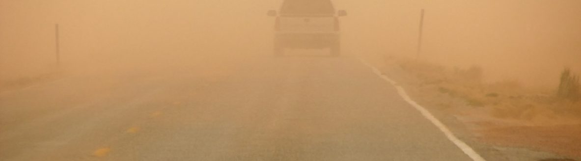 Driving along a highway into an orange sandstorm, visibility is reduced drastically. (iStock │ #140469297 - pancaketom)