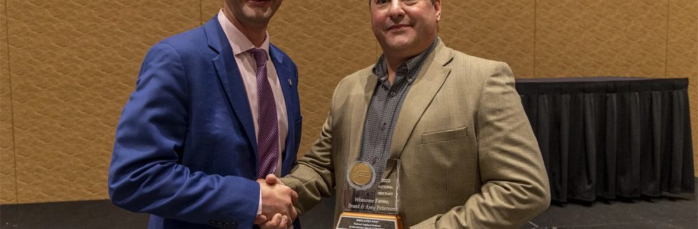 Brant Peterson accepts his award during the 2022 NSP Yield Contest banquet in Orlando, Fl. (Photo credit: National Sorghum Producers)