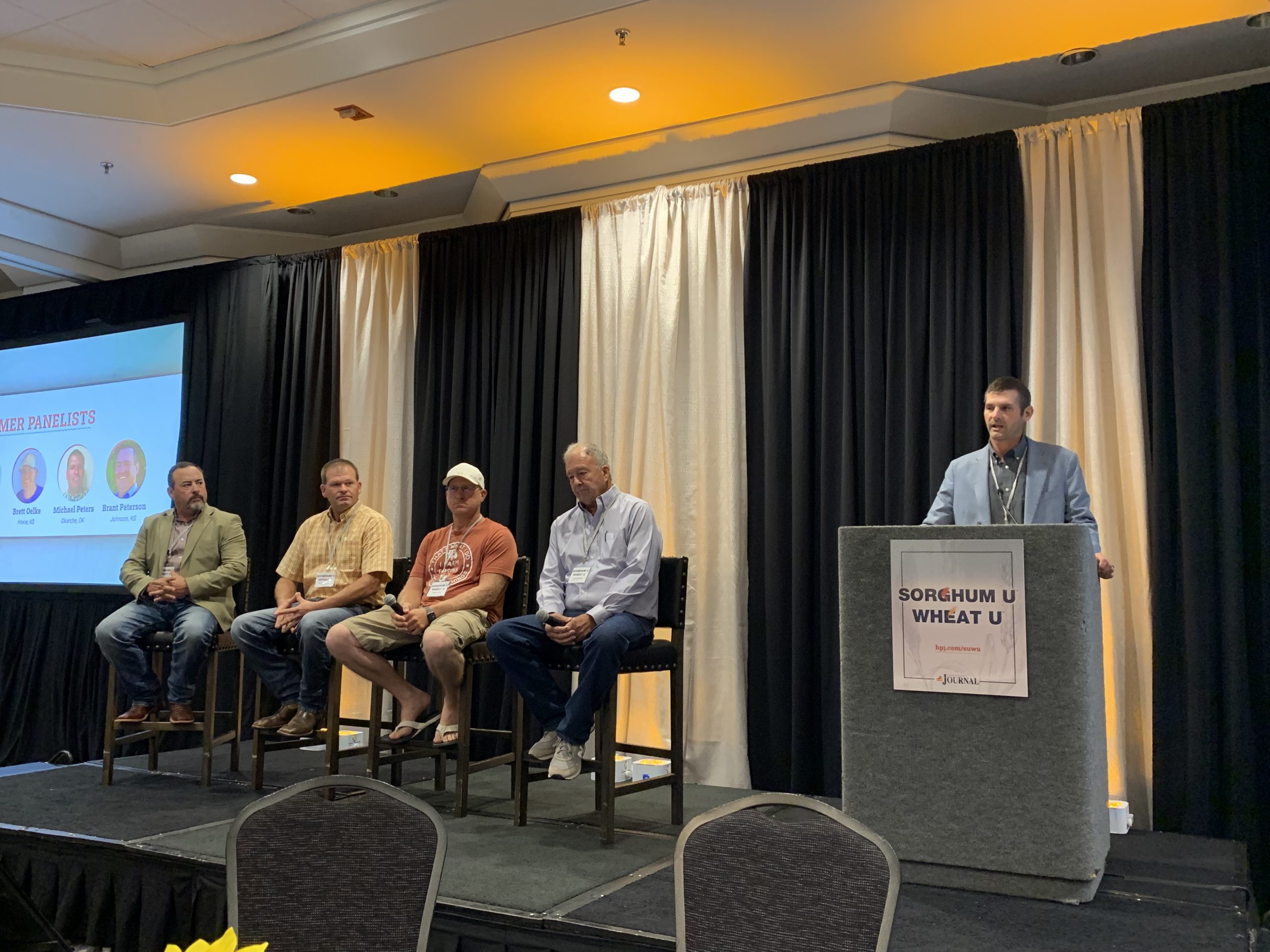 The farmer panel at Sorghum U Wheat U included moderator Craig Meeker and panelists: Brant Peterson, Michael Peters, Brett Oelke and Kent Winter. (Journal photo by Lacey Vilhauer.)