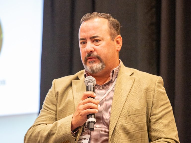 Brant Peterson, Johnson, Kansas, answers a question during the farmer panel at Sorghum U/Wheat U, Aug. 9 in Wichita, Kansas. (Journal photo by Kylene Scott.)