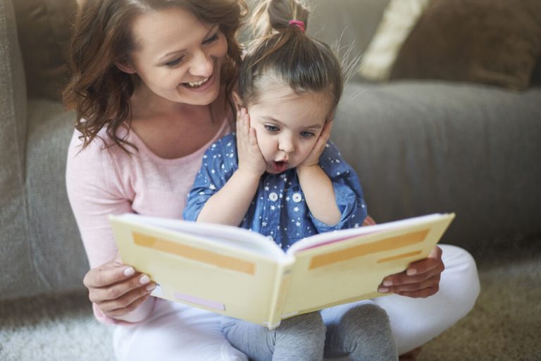 Mom reading to her daughter (Photo: iStock - gpointstudio)