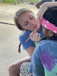 Shea Goodwin applies makeup. (Photo courtesy of University of Arkansas-Monticello.)