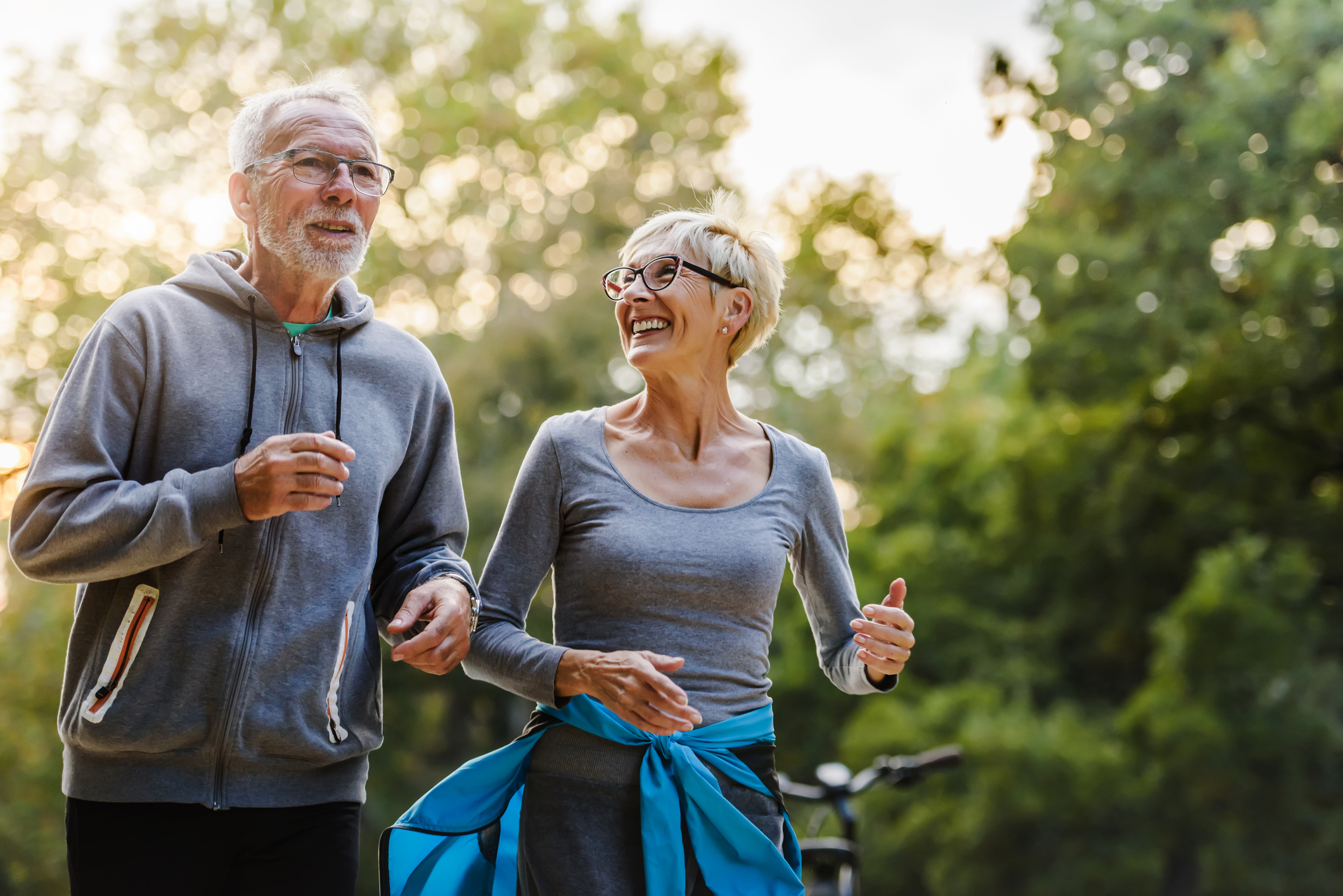 Smiling senior couple jogging in the park (iStock: Lordn)