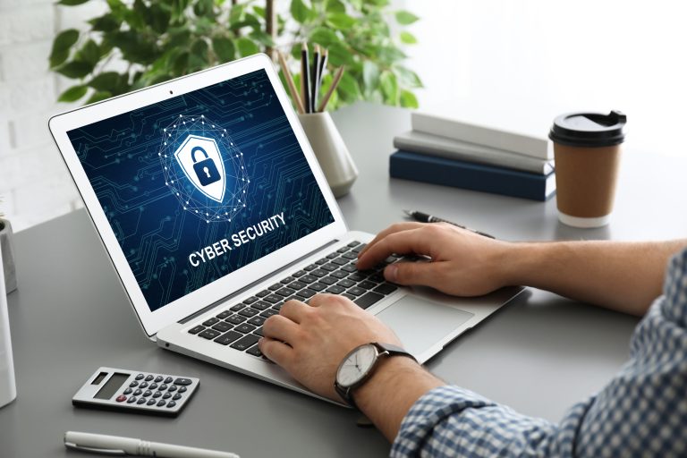 Cyber security concept. Man using application on laptop, closeup (iStock - Liudmila Chernetska)