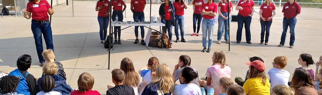 Arti Singh, associate professor, agronomy (far left), speaking to students at Fellows Elementary School in Ames, with representatives of the new Iowa State University group, Women in Agriculture and Artificial Intelligence (Photo courtesy of WIAA).