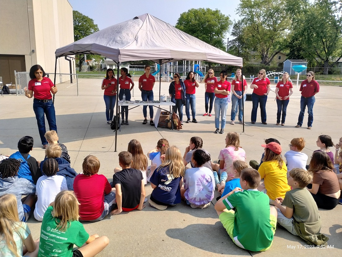 Arti Singh, associate professor, agronomy (far left), speaking to students at Fellows Elementary School in Ames, with representatives of the new Iowa State University group, Women in Agriculture and Artificial Intelligence (Photo courtesy of WIAA).