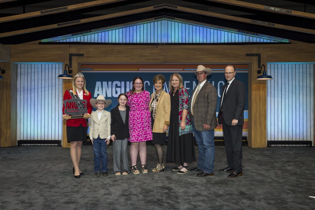 John McCurry of Burrton, Kansas, was presented with the American Angus Association’s inaugural Young Breeder Award during the American Angus Association® Awards Reception and Dinner in Orlando, Florida. Pictured from left are Kelsey Theis, Miss American Angus; Drew, Molly, Aubree, Mary, Melody, and John McCurry; and Mark McCully, American Angus Association CEO. (Photo courtesy of American Angus Association.)