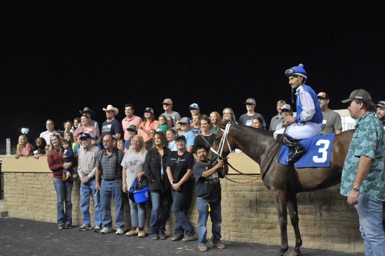 4-H members, parents and volunteers experience the winner's circle after a race and tour of Remington Park in Oklahoma City. (Photo by Oklahoma 4-H.)