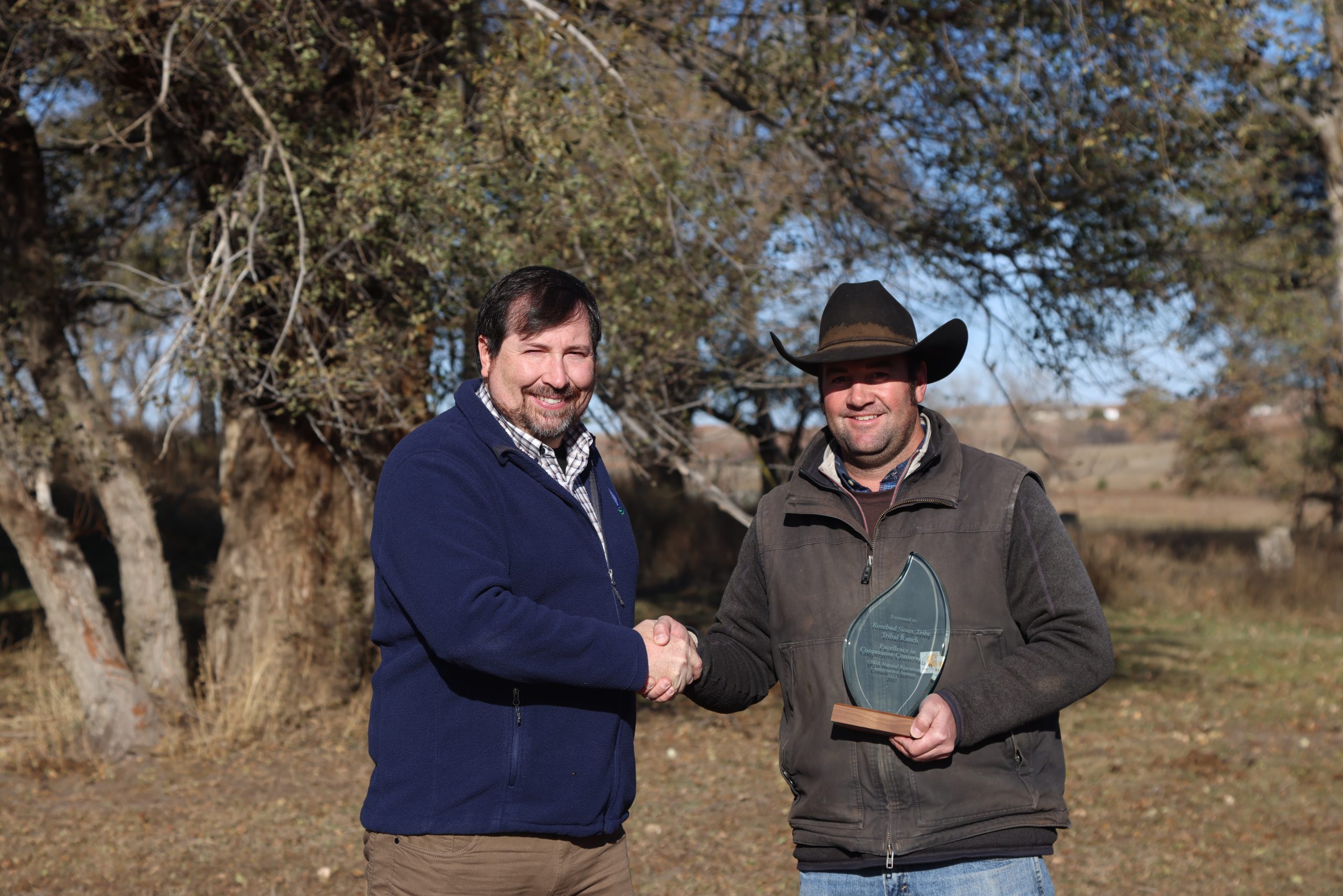 State Conservationist Tony Sunseri awards the Rosebud Sioux Tribe the Excellence in Cooperative Conservation Award. Pictured from left to right is Sunseri and Ranch Manager Joe Ross. (Photo courtesy of U.S. Department of Agriculture Natural Resources Conservation Service.)