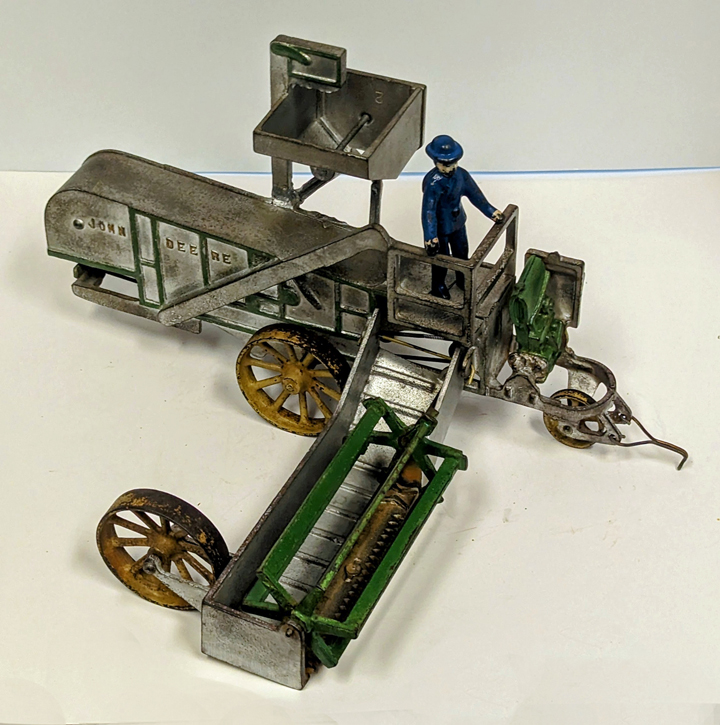 Pictured is the high selling consignment at the 2023 National Farm Toy Show Auction. The cast-iron John Deere combine made by Vindex in the early 1900s sold for $10,000. (Photo courtesy of Toy Farmer Publications.)