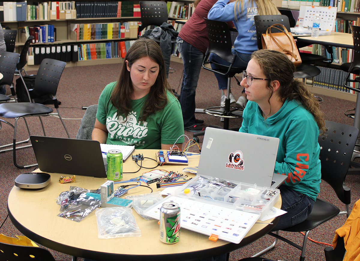 From left are Carrie Johns, Gering High School, ag-FFA teacher and advisor, and Kasey Trocke, Lennox Junior and Senior High ag-FFA teacher and advisor, review instructions before starting work on their microcontrollers. (Photo by Troy White.)