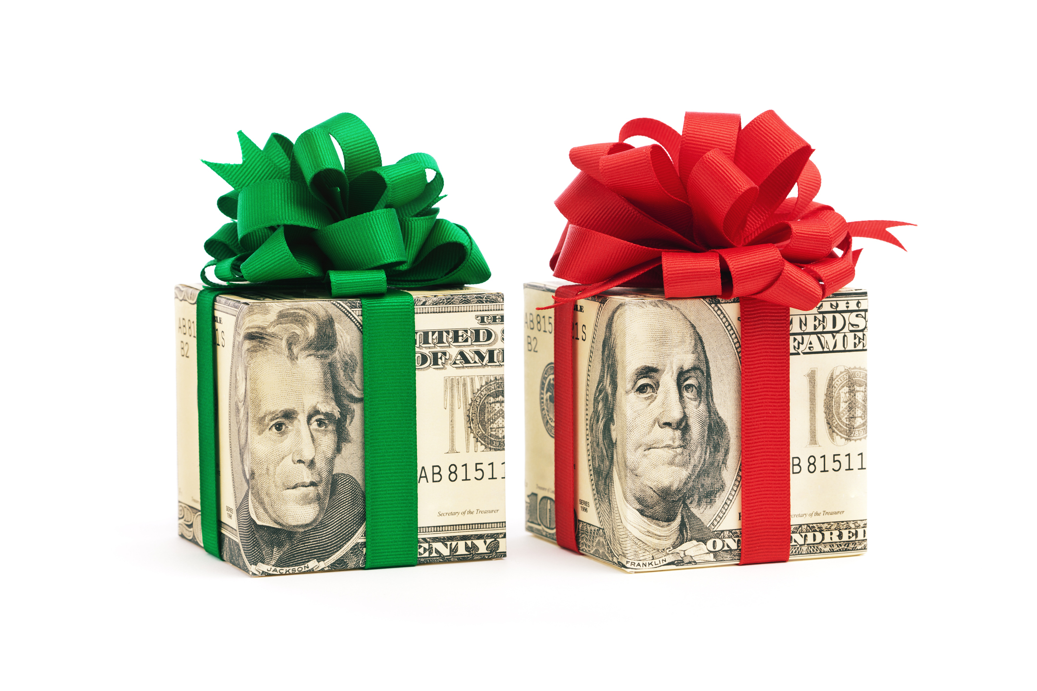 A group of gift packages wrapped in different U.S. dollar denominations of twenty, and hundred dollar bills, decorated with red and green bows. (Photo: iStock-YinYang)
