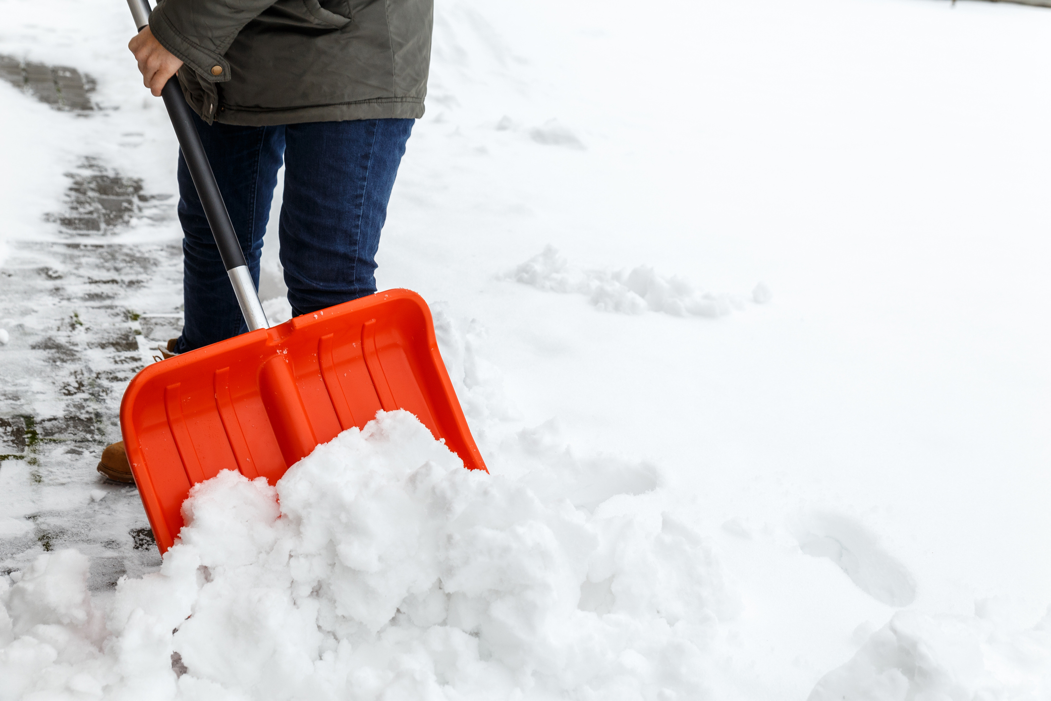 Woman with shovel cleaning snow. (Photo: iStock - Tanya-stock)