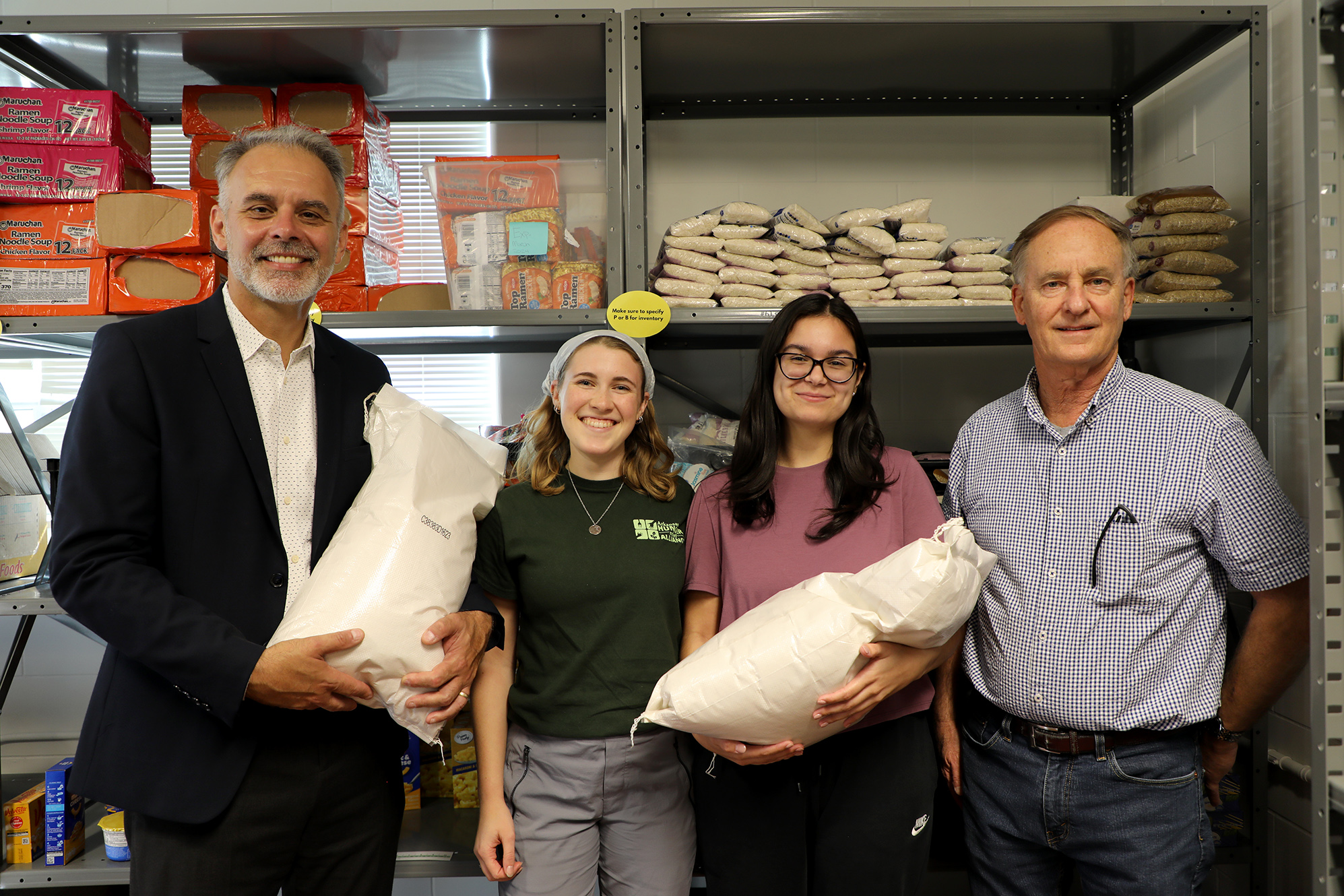 Arkansas Agricultural Experiment Station Director Jean-Francois Meullenet, left, and Assistant Director Nathan McKinney, right, joined student volunteers Katelyn Helberg and Caroline Wilson for the intake of rice donations to the Jane B. Gearhart Full Circle Food Pantry at the University of Arkansas. (Photo by Karli Yarber, University of Arkansas System.)