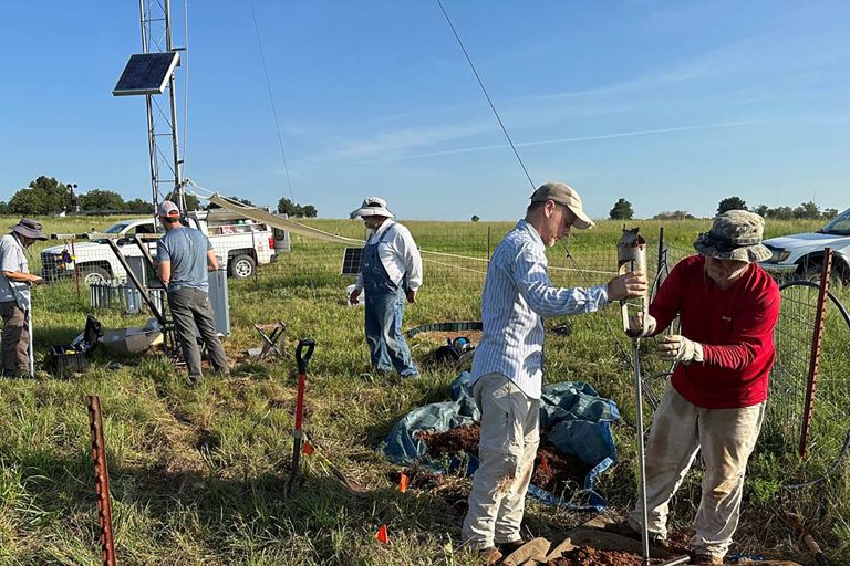 Researchers from Oklahoma State University and the University of Oklahoma prepare to install new soil water content sensors at an Oklahoma Mesonet site as part of the Oklahoma Hydronet initiative. The Hydronet system will also measure water stored in soil, aquifers and reservoirs. (Photo by OSU Agriculture.)