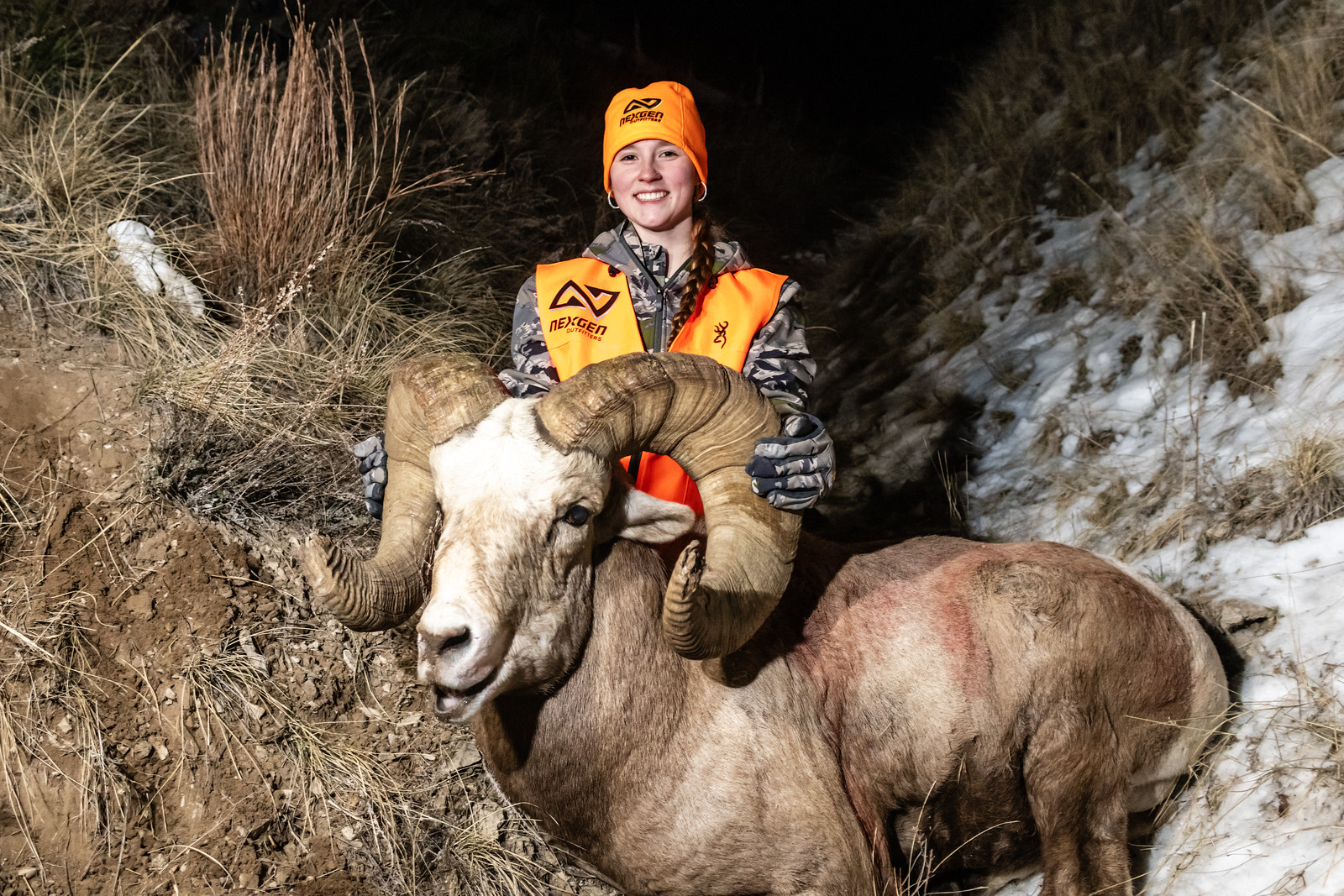 Kiersten Black, 15, poses with the bighorn sheep ram after her successful hunt. (Photo by Justin Haag, Nebraskaland Magazine and Nebraska Game and Parks Commission.)