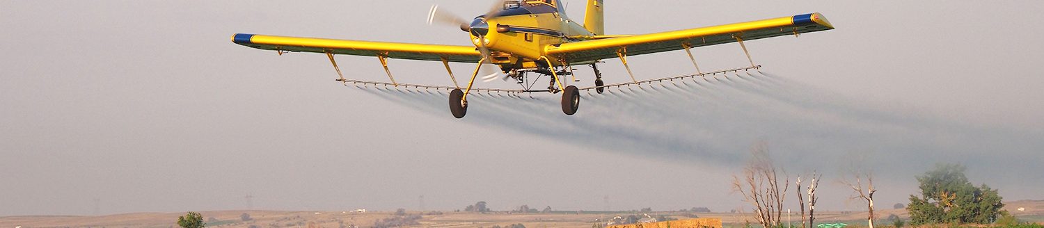Plane makes an aerial application on a field in western Nebraska. (Photo by Gary Stone.)