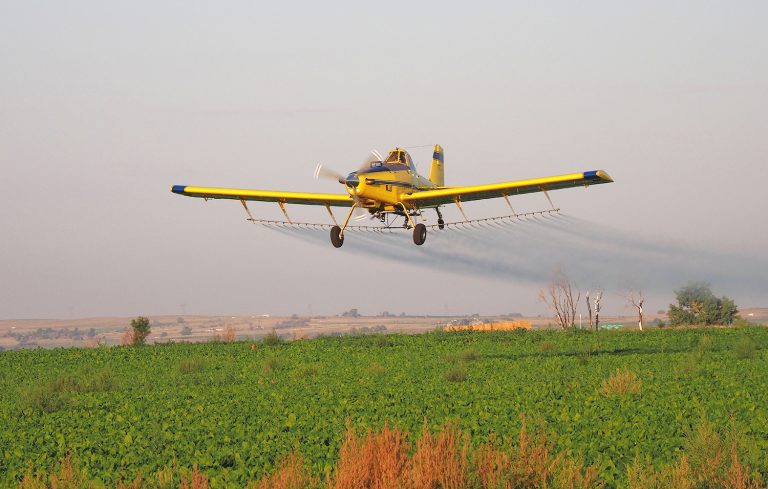 Plane makes an aerial application on a field in western Nebraska. (Photo by Gary Stone.)