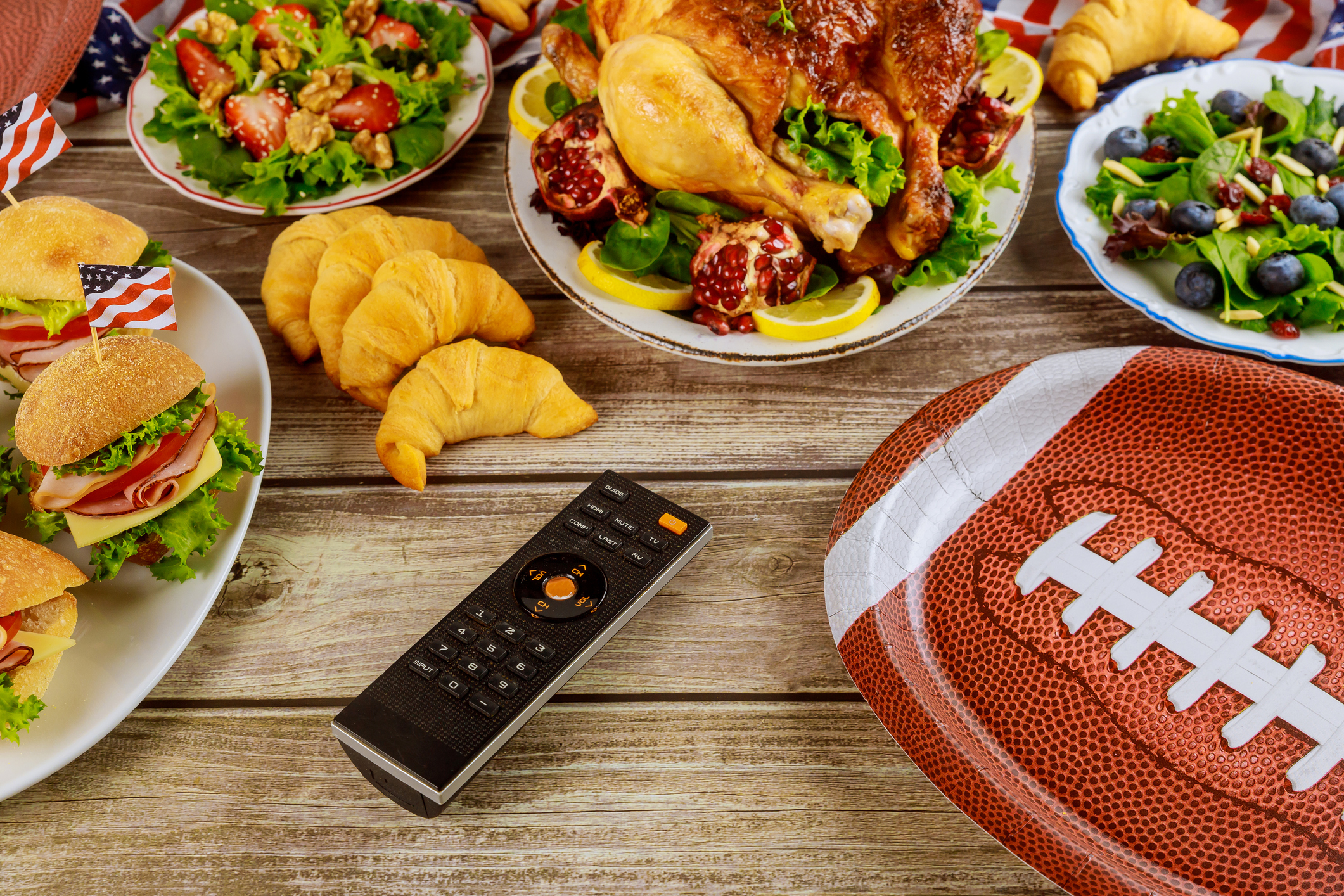 Party table with remote control for sport watching american football game on tv. (Photo: iStock - 500)