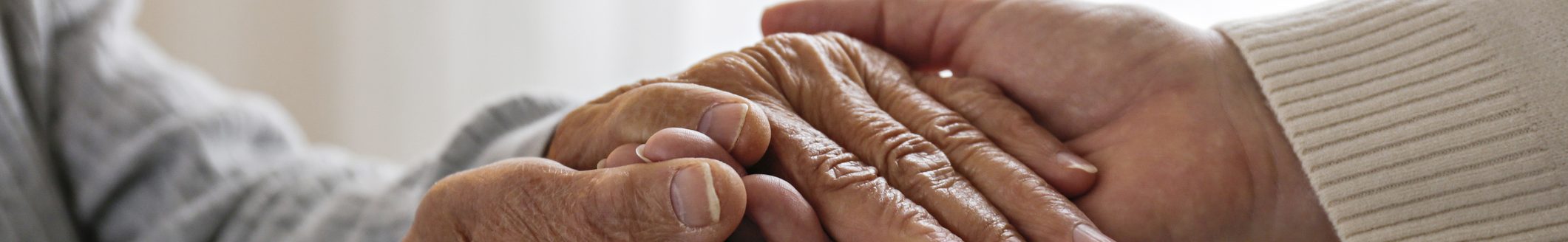 Mature female in elderly care facility gets help from hospital personnel nurse. Cropped shot of senior woman's hands with aged wrinkled skin and care giver. (Photo: iStock - Evrymmnt)