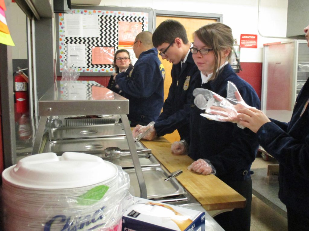 FFA members serving dinner at the Manzanola FFA Service Auction. (Courtesy photo.)