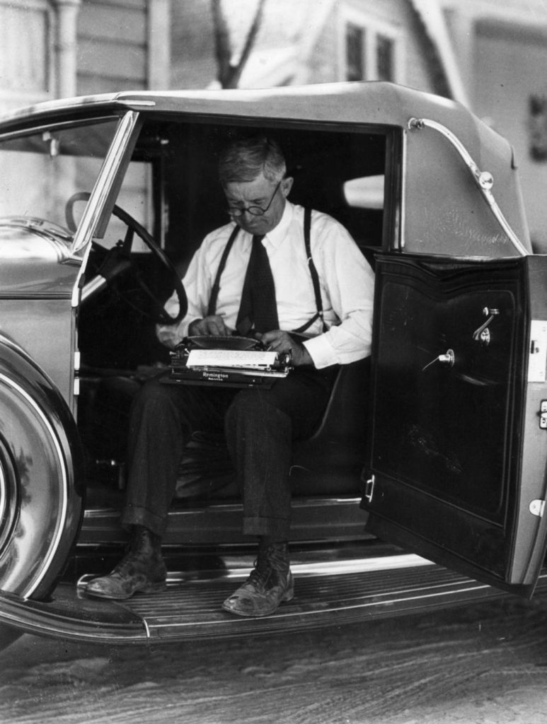 Will Rogers in his own automobile typing newspaper column between shots on a Fox movie set, circa 1934-1935. (Photo courtesy Will Rogers Memorial Museum.)