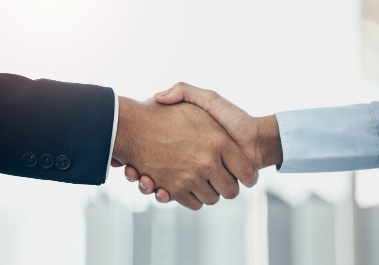 Business people shaking hands. (Photo: iStock - PeopleImages)