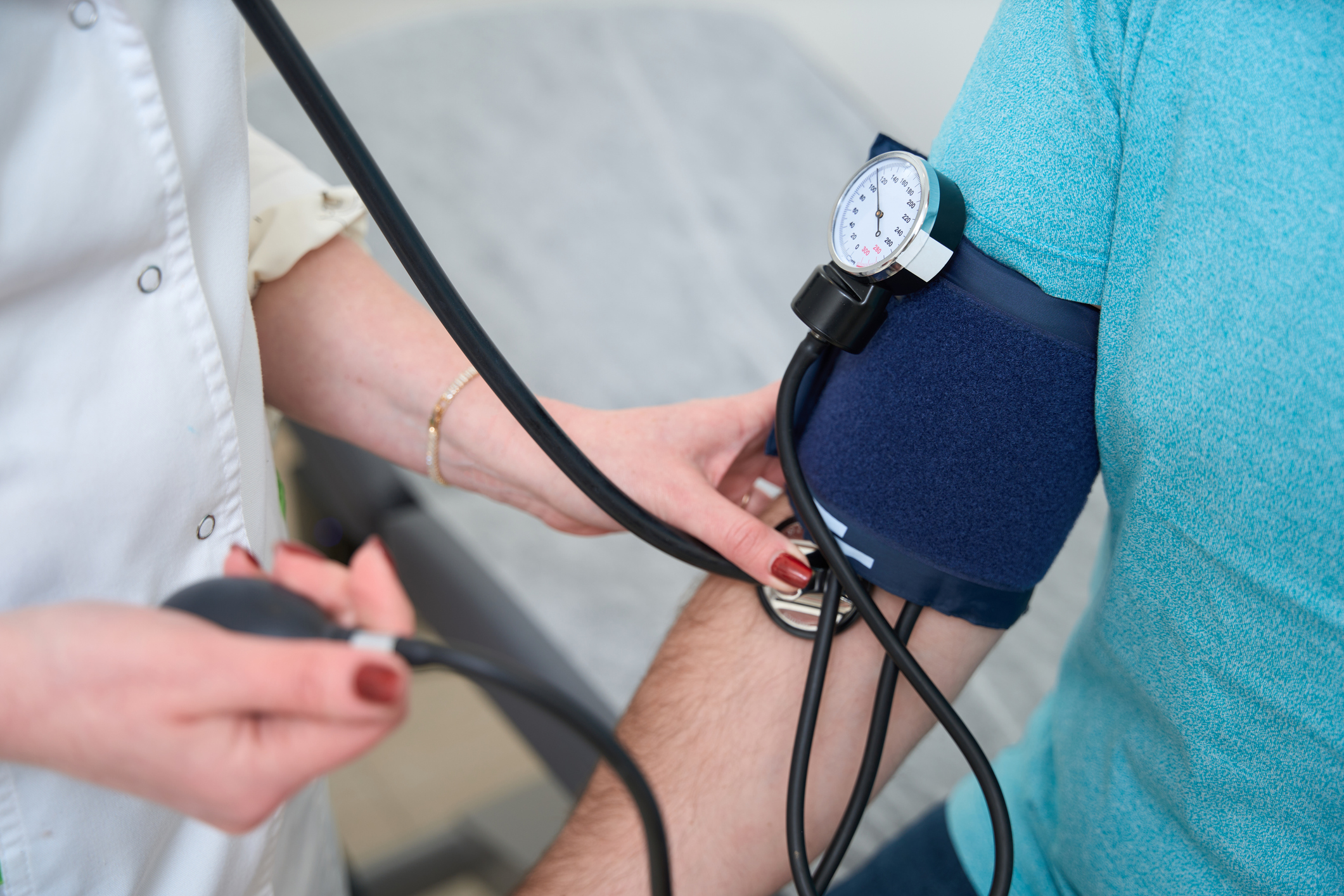 Close up of doctor checking man patient arterial blood pressure. (Photo: iStock - yacobchuk)