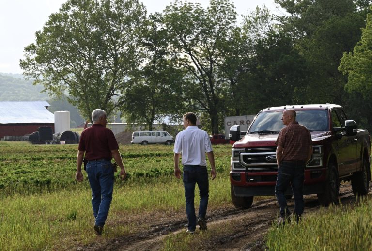 In the above photo, Huma Global Chief Sales and Marketing Officer Fred Nichols (at right), along with Huma Regional Agronomist Barrett Smith (center), meet with a farmer (pictured at left) to discuss the plant health of his row and specialty crops. (Courtesy photo.)