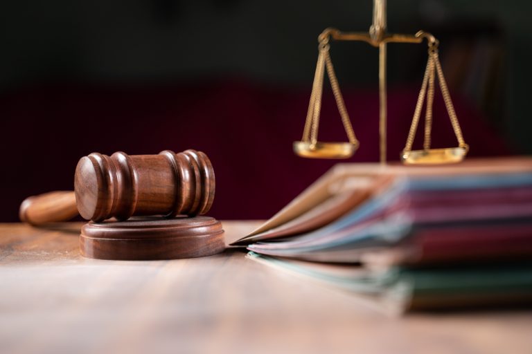 focus on hammer, group of files on judge table covered with dust - concept of pending old cases or work at judicial court. (Photo: iStock - lakshmiprasad S)