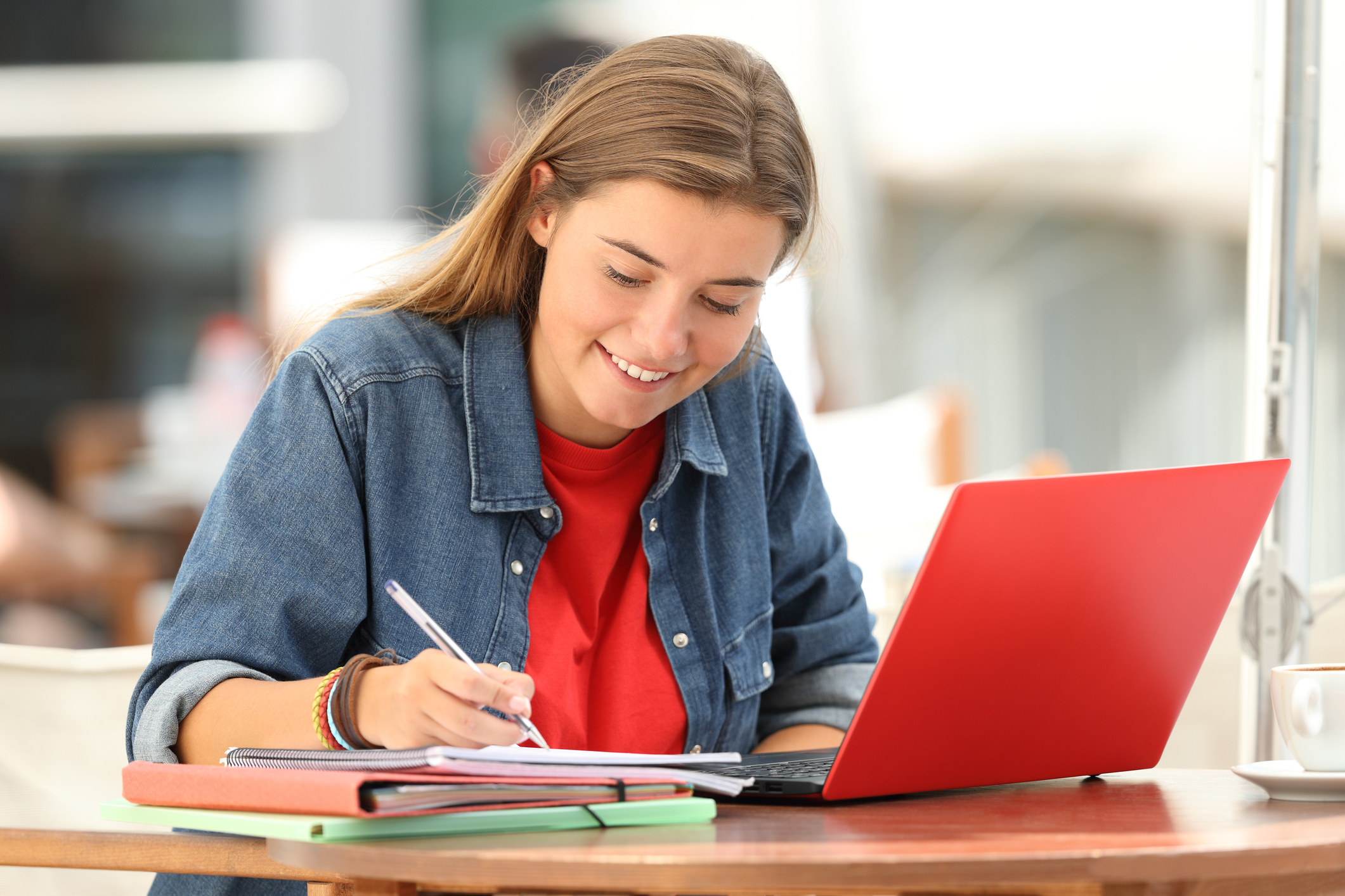 Single student e-learning on line with a laptop and taking notes (Photo: iStock - AntonioGuillem)