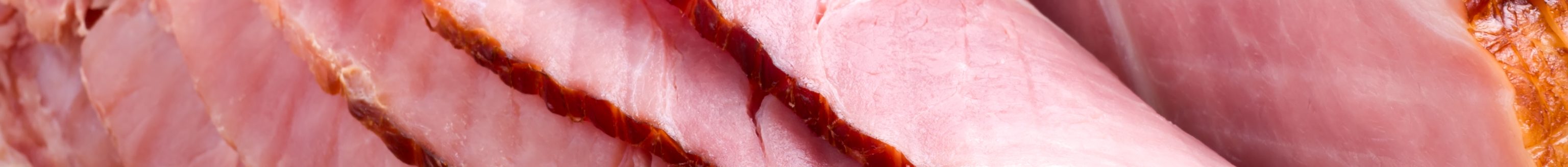 Closeup of delicious whole baked sliced ham with fresh strawberries and figs on holiday table. (Photo: iStock - evgenyb)