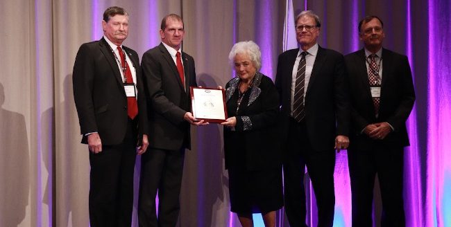 The late Bill Prestage was honored as the 2024 Pork Industry Hall of Fame recipient commemorated by (from left) Ron Prestage, National Pork Producers Council President Scott Hays, Martha Prestage, Scott Prestage and John Prestage. (Courtesy photo.)