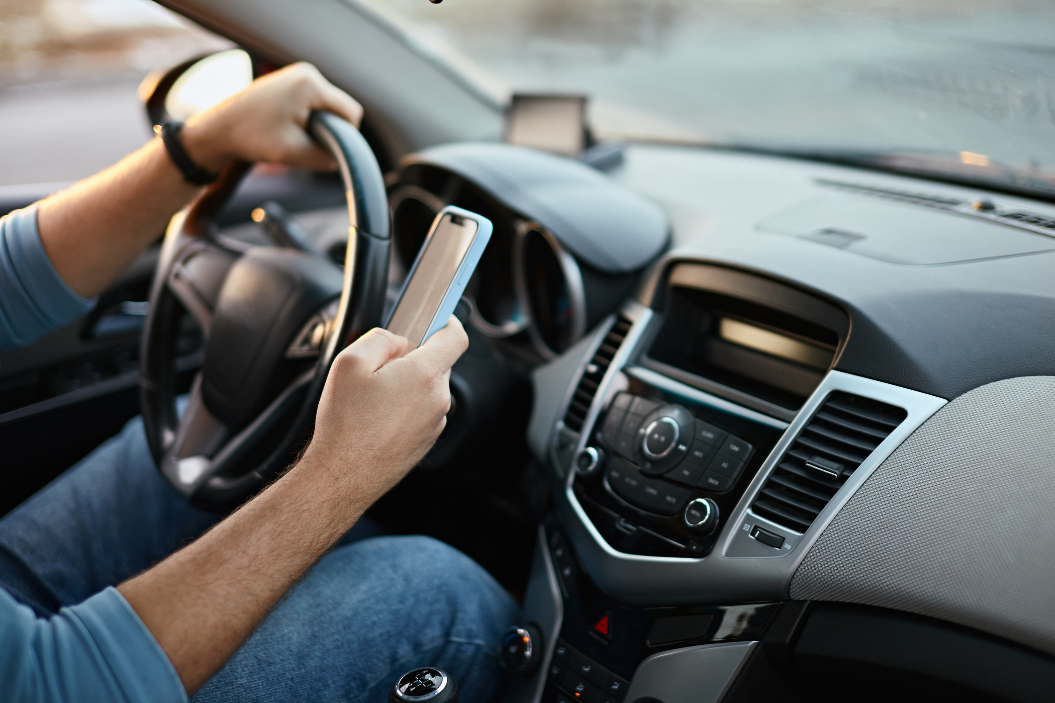 Driver using mobile phone while driving. (Photo: iStock - perfectlab)