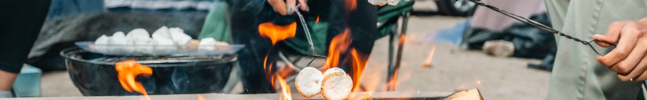 A group of friends roasting marshmallows on a campfire at their campsite. (Photo: iStock - halbergman)