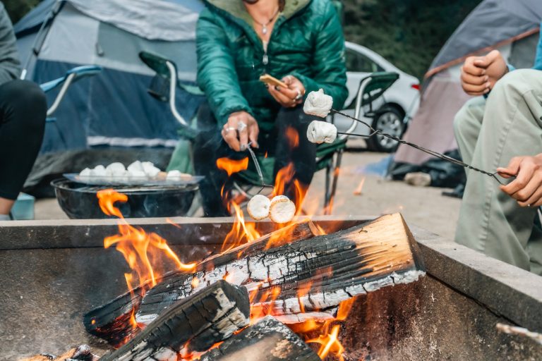 A group of friends roasting marshmallows on a campfire at their campsite. (Photo: iStock - halbergman)