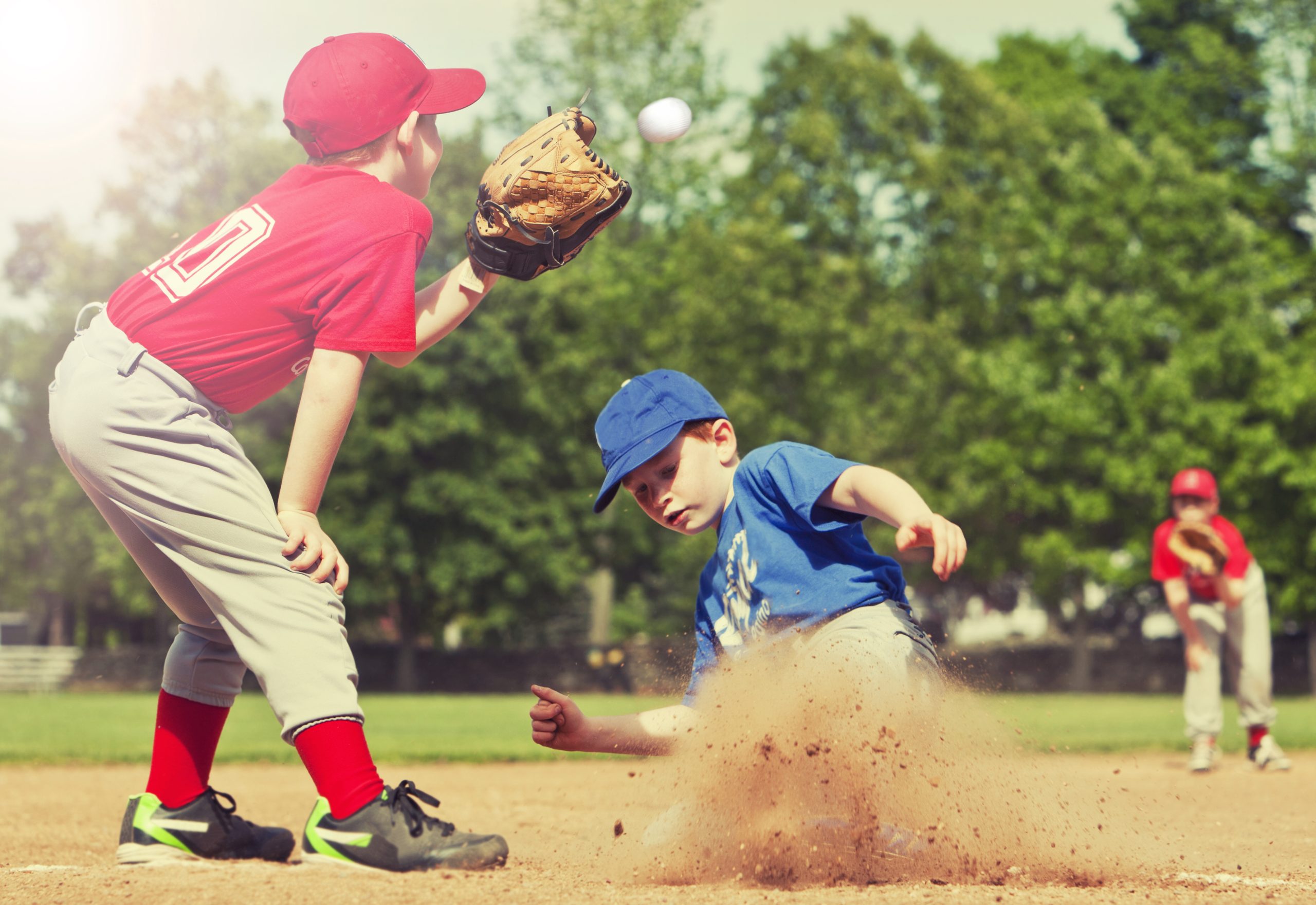 Boy sliding into base during a baseball game (Photo: iStock - stu99)