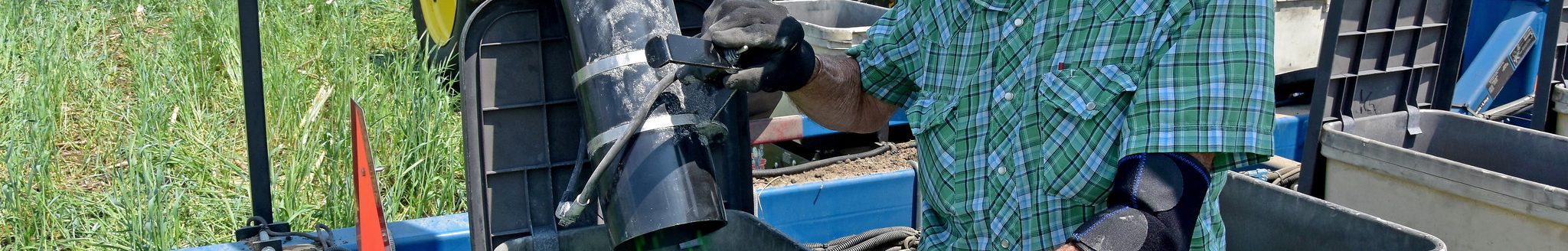 A farmer pours soybean seed into his planter prior to no-till planting into cereal rye. (Photo courtesy of Jason Johnson/Iowa NRCS)