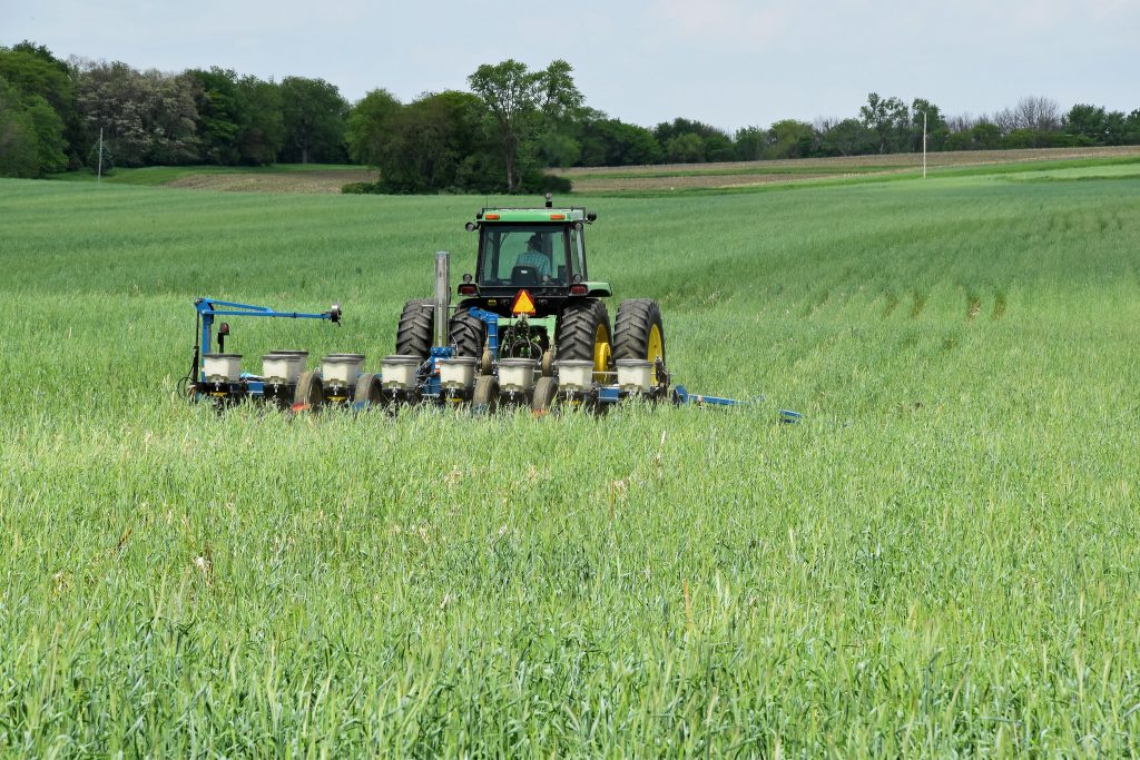 A farmer plants soybeans into a cover crop stand of cereal. (Photo courtesy of Jason Johnson/Iowa NRCS)