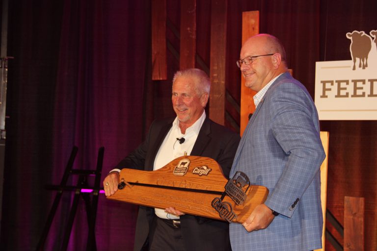 (Left) Glen Dolezal received the Industry Achievement Award from John Stika on Aug. 20 at Certified Angus Beef’s Feeding Quality Forum in Dodge City, Kansas. (Journal photo by Dave Bergmeier.)