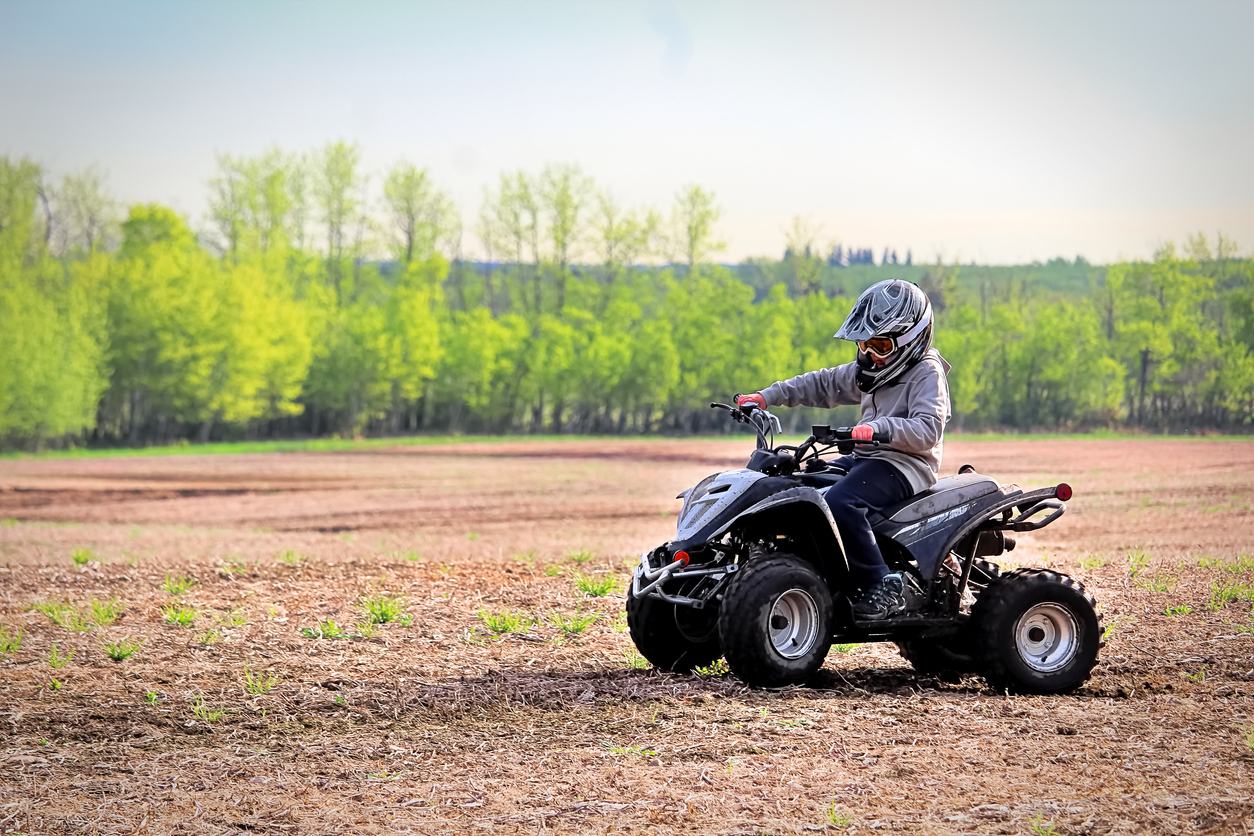 A young boy quading in a spring field. (Photo: iStock - Akchamczuk)