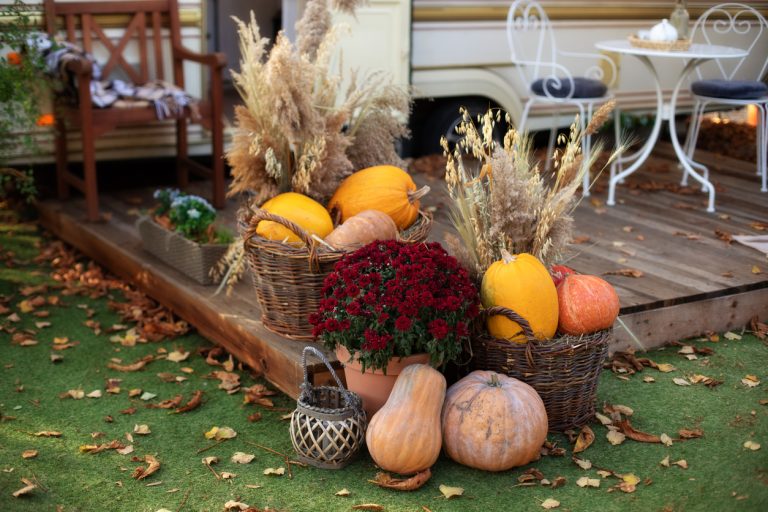 Decorated entrance to house with pumpkins in basket and chrysanthemum. Front Porch decorated for fall season. (Photo: iStock - Тодорчук Екатерина)