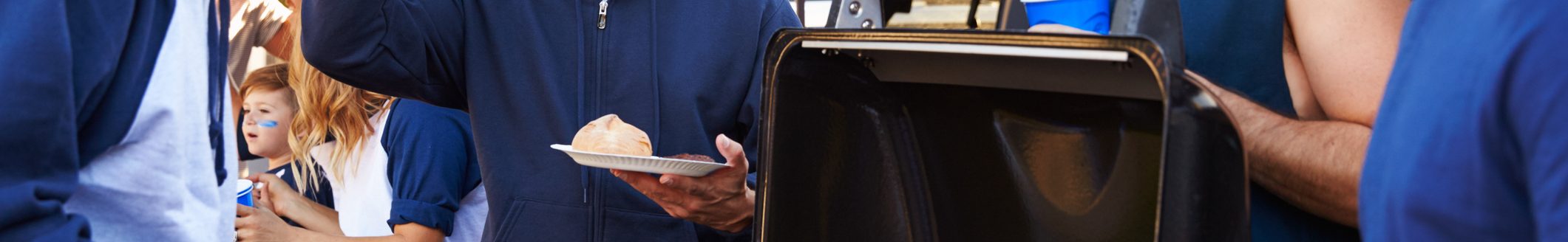 Group Of Male Sports Fans Tailgating In Stadium Car Park (Photo: iStock - monkeybusinessimages)