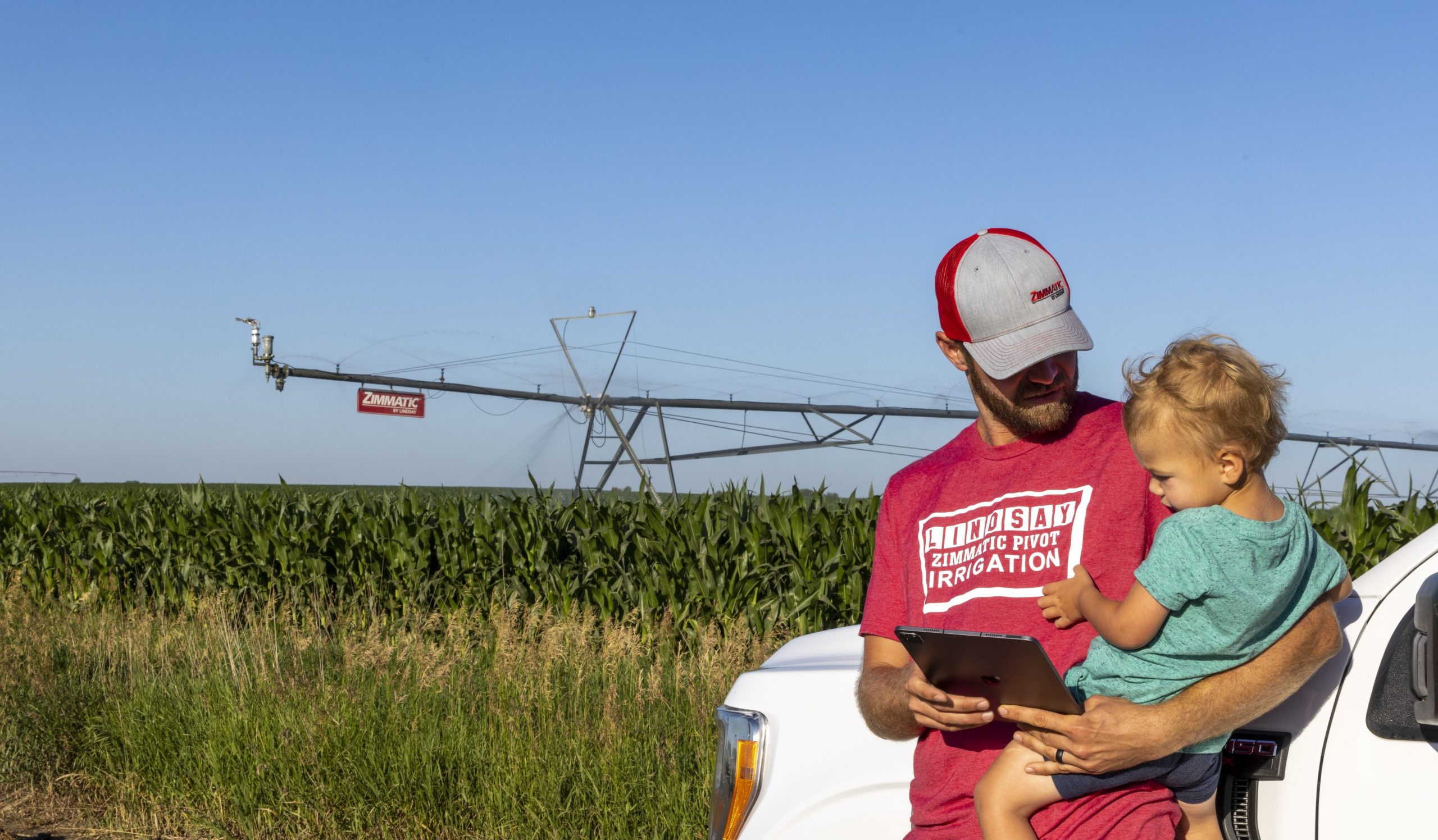 A grower is pictured by his Zimmatic center pivot. (Courtesy photo.)