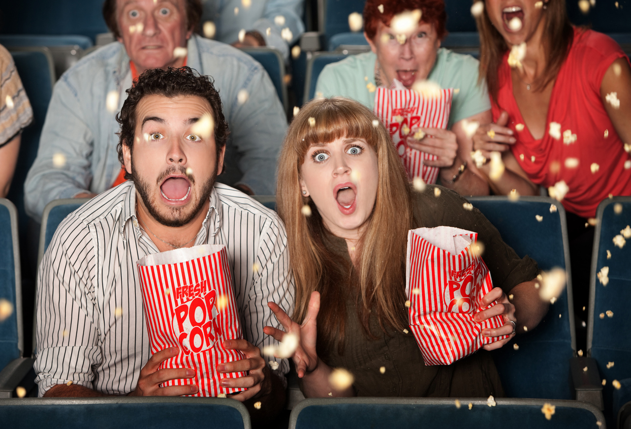 Group of frightened people watching movie spill popcorn (Photo: iStock - CREATISTA)