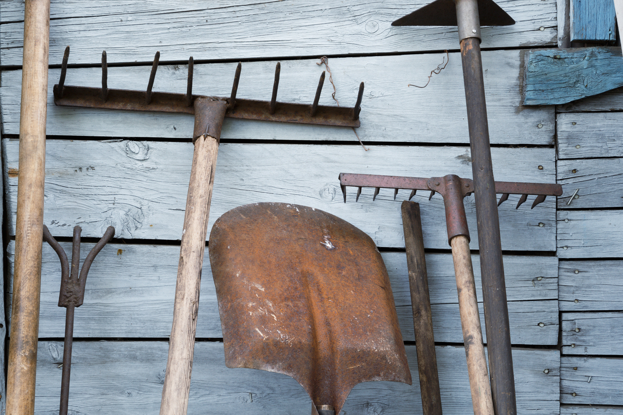 Old rusty traditional tools, instruments, implements and farm or household equipment on wooden shed wall background. (Photo: iStock - AVolke)