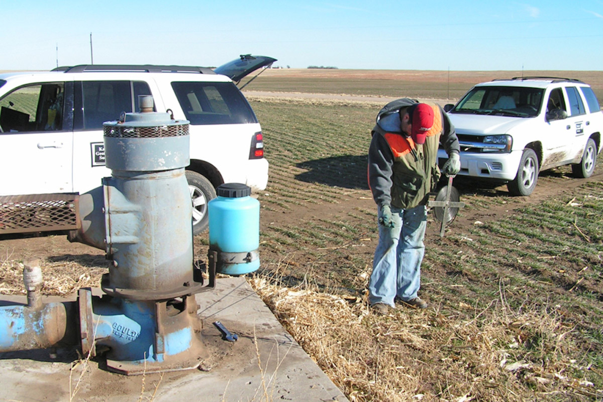 A KGS team member measures groundwater levels in a well in western Kansas. (Photo: Kansas Geological Survey)