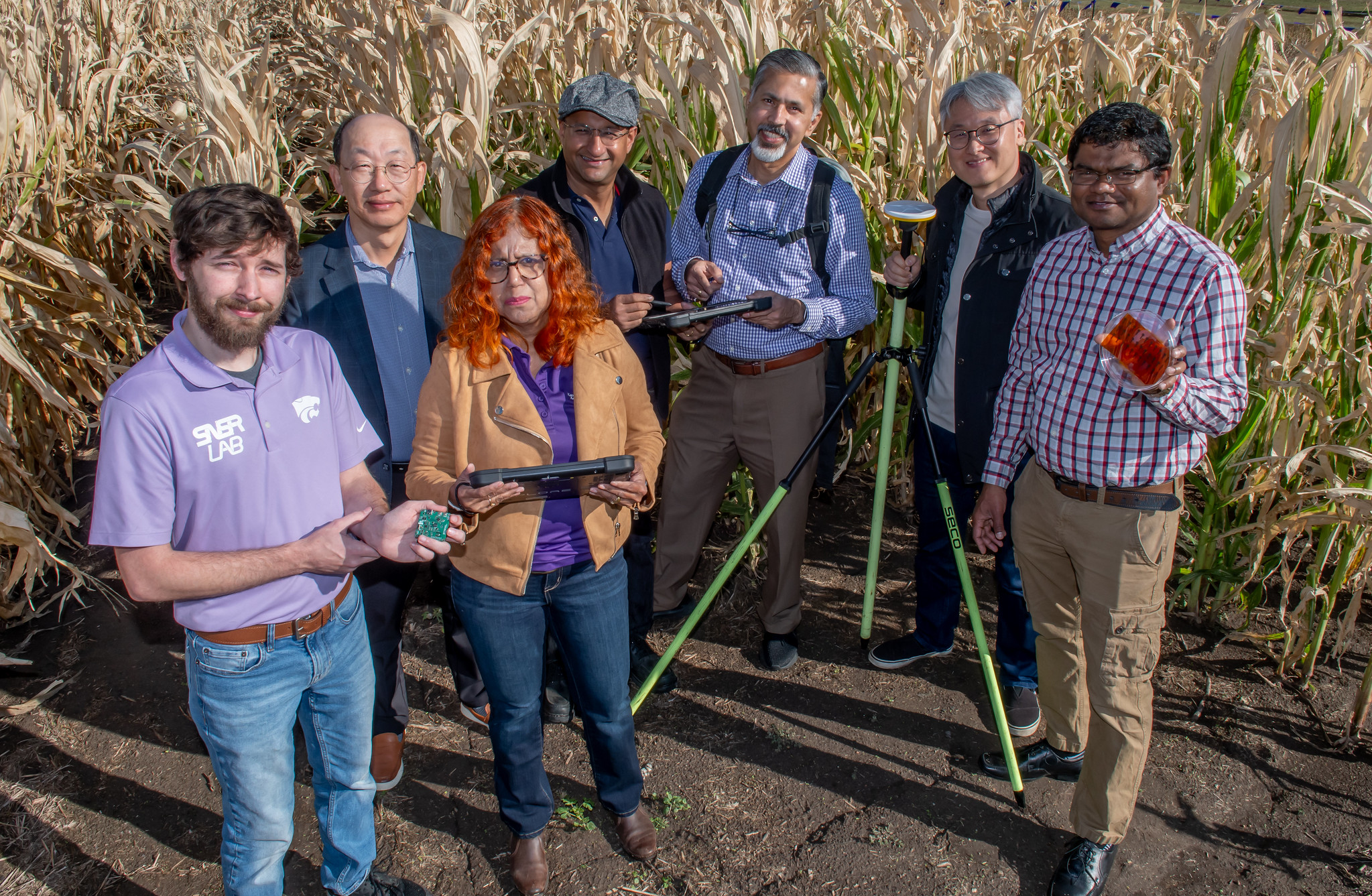 K-State researchers are beginning a project to develop sensors that that can more accurately measure soil properties. Pictured, l to r, are Garrett Peterson (electrical engineering), Jaebeom Suh (marketing), Ganga Hettiarachchi (agronomy), Bala Natarajan (electrical and computer engineering), Raj Khosla (agronomy), Jeongdae Im (civil engineering), Suprem Das (industrial and manufacturing systems engineering).(Photo: K-State Research and Extension news service)