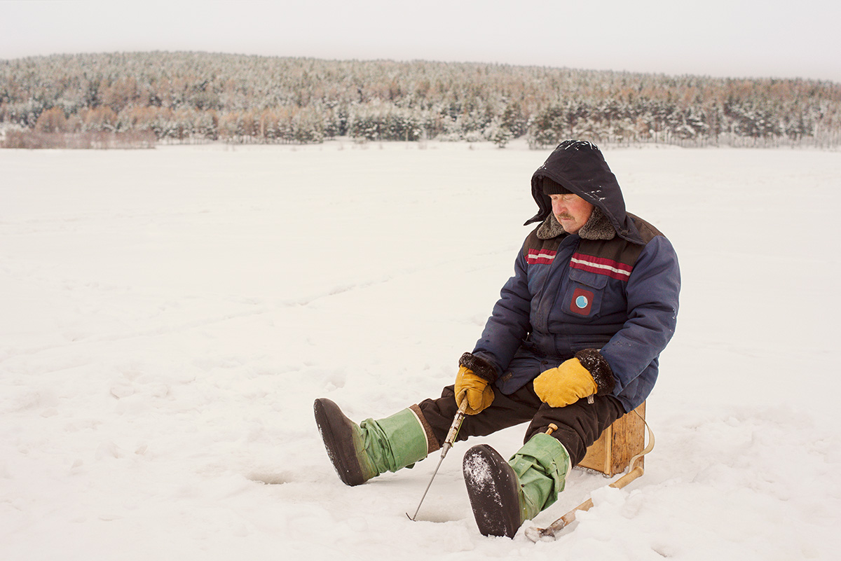 Man ice fishing in frozen lake. (Photo: Adobe Stock │ #233665479 - Cavan for Adobe)