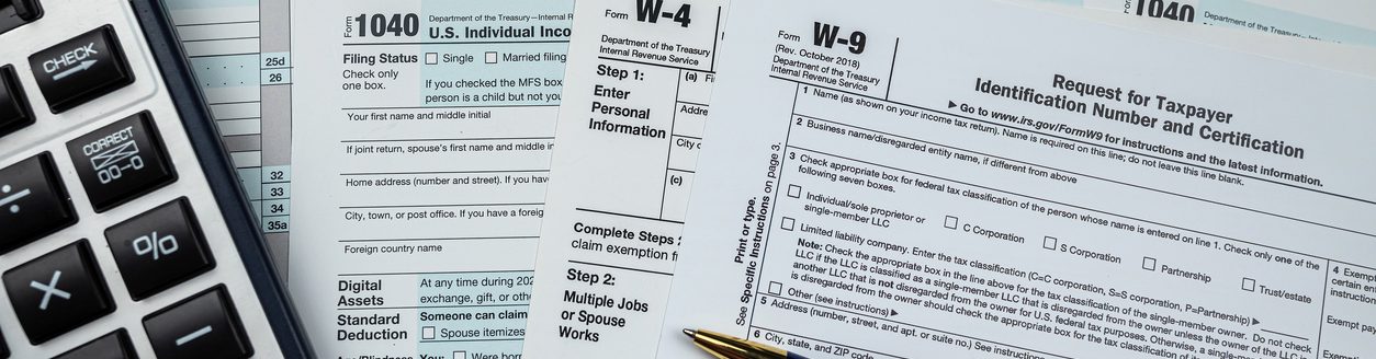 Blank 1040 us tax form with calculator and keyboard on office desk. (Photo: iStock │ #1469972260 - alfexe)